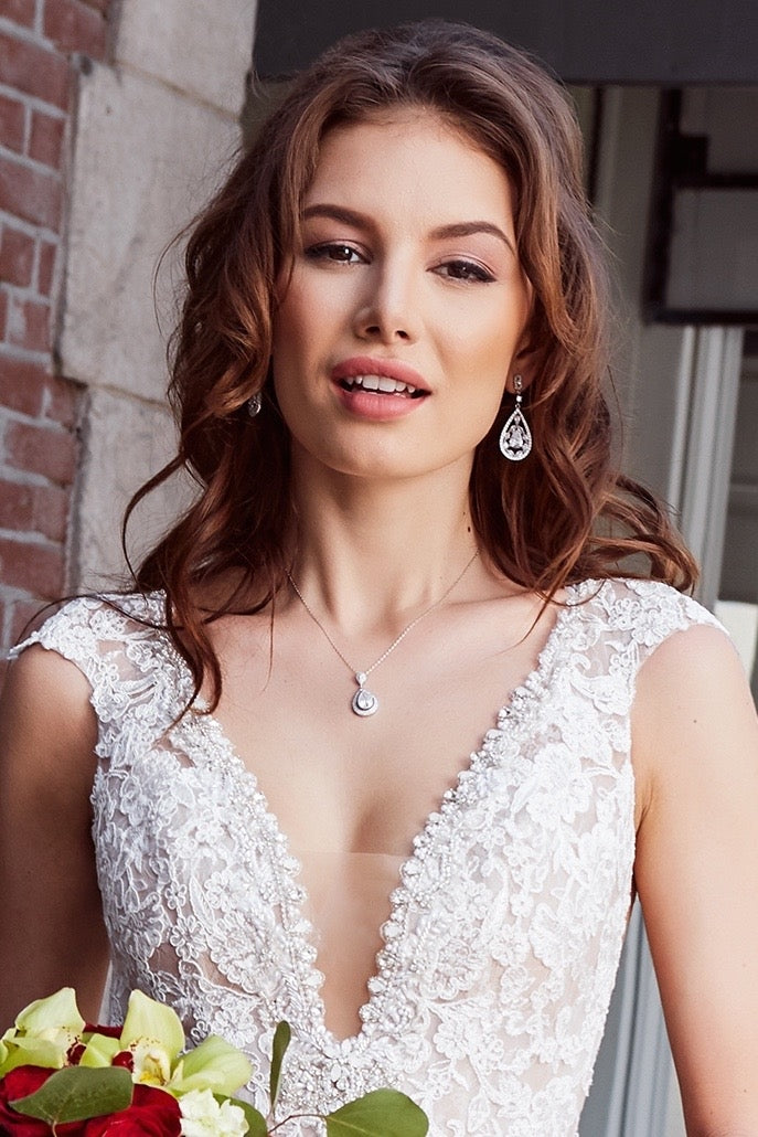 Free Photos - A Beautiful Woman Wearing A Stylish V-neck Dress, Showcasing  An Elegant And Fashionable Appearance. The Dress Is Complemented By A Pair  Of Earrings, Further Enhancing The Woman's Attractive Look. |